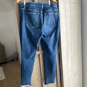 Joes jeans. Very stretchy with distressed holes in  knees .